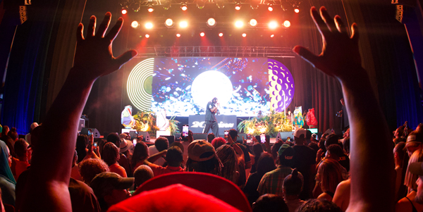 Picture showing the stage at a 2 Chainz's concert featuring an LED Neon vinyl record.